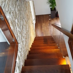 Wooden stairs with glass balustrade