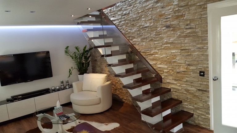 Wooden stairs with glass balustrade