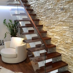 Wooden stairs with glass balustrade